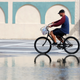 A cyclist rides past an area flooded during a King Tide, an especially high tide, Tuesday, Oct. 9, 2018, in Miami.